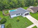 Aerial view of a beautiful home with a pool and lush landscaping at 34 Aaron Cir, Ormond Beach, FL 32174