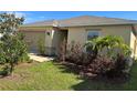 Inviting single story home featuring an attached garage and manicured lawn at 1509 Venice Ln, Davenport, FL 33896