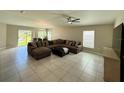 Open-concept living room boasts tile floors and lots of natural light at 1509 Venice Ln, Davenport, FL 33896