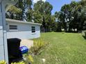 Spacious backyard area with well maintained lawn and small patio space at 705 Grandview Ave, Altamonte Springs, FL 32701
