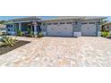 Attractive home boasting a double garage and patterned brick driveway at 10298 Sw 96Th Loop, Ocala, FL 34481