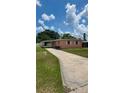 Inviting single-story home featuring a long driveway and a covered carport at 1923 Beechwood Dr, Lakeland, FL 33803
