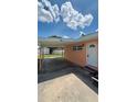 View of the home's side entrance and attached carport with a storage shed at 1923 Beechwood Dr, Lakeland, FL 33803