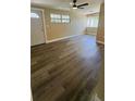 Bright living room featuring wood-look floors, a ceiling fan, and natural light at 1923 Beechwood Dr, Lakeland, FL 33803