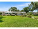 Charming home with a lush lawn, mature plantings and flowers, enhancing its curb appeal at 2110 Reaney Rd, Lakeland, FL 33803