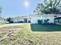 Inviting single-story home with a well-manicured lawn and a spacious driveway on a sunny day at 4128 Palo Alto Dr, Lakeland, FL 33813