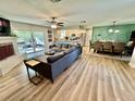 Open-concept living room, kitchen and dining room with hardwood floors and access to the outdoor patio at 4128 Palo Alto Dr, Lakeland, FL 33813