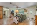 Inviting living room featuring neutral colors, comfortable seating, tile flooring, and ample natural light at 21551 Lake Seneca Rd, Eustis, FL 32736