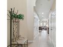 Bright hallway featuring tile floors, neutral walls, and a glimpse into the living area at 5935 Tivoli Gardens Blvd, Orlando, FL 32829