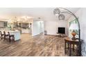 Open-concept living area with wood-look tile floors and seamless flow to the modern kitchen at 1625 Itchepackesassa Dr, Lakeland, FL 33810