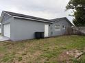 Exterior view of the home showcasing the garage and fenced yard at 606 Lakespur Ln, Altamonte Springs, FL 32714