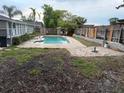 Backyard pool area showcasing the pool, patio, and wooden fencing at 606 Lakespur Ln, Altamonte Springs, FL 32714