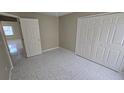 This bedroom features tile floors, double door closet, and neutral walls at 1416 Silverthorn Dr, Orlando, FL 32825