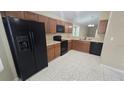 Well-equipped kitchen features black appliances, wood cabinets, and easy access to the living areas at 1416 Silverthorn Dr, Orlando, FL 32825
