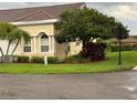 Landscaped yard with lush green grass and mature tree in this suburban neighborhood at 2202 Garden Lake Dr, Winter Haven, FL 33884
