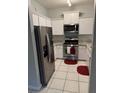 Bright kitchen features stainless steel appliances, white cabinets, and granite countertops at 2202 Garden Lake Dr, Winter Haven, FL 33884