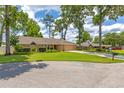 Lovely single-story home with a well-kept lawn, mature trees, and convenient garage access at 2921 Se 38 Pl, Ocala, FL 34480