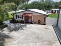 Attractive home featuring covered porch, vibrant flowers and a spacious driveway at 1423 Spruce N Rd, Lakeland, FL 33809