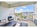 Relaxing balcony with seating offers a serene view of the neighborhood and ample natural light at 3175 Feltrim Pl # 405, Kissimmee, FL 34747