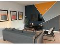 Comfortable living room with modern decor, stylish furniture, and a contemporary accent wall at 3175 Feltrim Pl # 405, Kissimmee, FL 34747