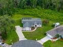Aerial view showcases a well-maintained property with a screened pool and lush backyard at 3952 Laurel Branch Dr, Lakeland, FL 33810