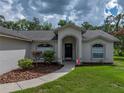 Close-up of the front entrance with a decorative walkway, arched entryway and well-kept landscaping at 3952 Laurel Branch Dr, Lakeland, FL 33810