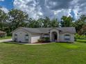 Beautiful single-story home with lush green lawn and mature trees in a serene setting at 3952 Laurel Branch Dr, Lakeland, FL 33810
