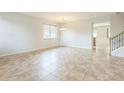 Bright and spacious living room with neutral tile flooring, ample natural light, and a view into the kitchen at 1769 Strathmore Cir, Mount Dora, FL 32757