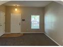 Inviting living room features fresh paint, carpet, window with blinds, and lots of space at 10303 Park Commons Dr, Orlando, FL 32832