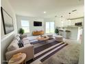 Bright, staged living room with modern furniture, large windows, and access to the backyard at 222 Carpenters Way # 71, Lakeland, FL 33805