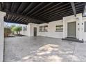 Wide angle view of the concrete carport with covered ceilings leading to the front door of the home at 2800 E Anderson St, Orlando, FL 32803