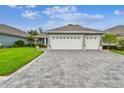 Inviting home features a spacious driveway, a well-kept lawn, and a convenient two-car garage at 7991 Lake James Blvd, Lakeland, FL 33810
