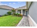 Beautiful home with a well-manicured lawn, lush landscaping, and a charming covered front porch at 7991 Lake James Blvd, Lakeland, FL 33810