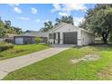 Single story home with a driveway and a well-maintained lawn on a bright day at 9413 5Th Ave, Orlando, FL 32824