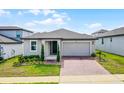 Charming single-story home featuring a two-car garage and a well-manicured lawn at 2296 Crossbow St, Clermont, FL 34715