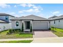Charming single-story home featuring a two-car garage and a well-manicured lawn at 2296 Crossbow St, Clermont, FL 34715