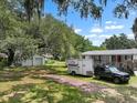 Residential home featuring a large lot, shed, and trailer at 2912 Fletcher Ave, Lakeland, FL 33803