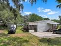 Residential house with front porch and shed in backyard at 2912 Fletcher Ave, Lakeland, FL 33803
