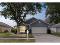 Inviting single-story home with a two-car garage and mature landscaping in a tranquil setting at 4217 Kingbird Ct, Orlando, FL 32826