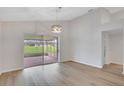 Spacious living area with wood floors and sliding doors leading to a screened lanai at 4217 Kingbird Ct, Orlando, FL 32826