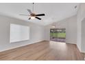 Bright living room featuring wood floors, a ceiling fan, and sliding glass doors to the lanai at 4217 Kingbird Ct, Orlando, FL 32826
