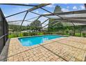 Screened-in pool with brick patio, offering a private and relaxing outdoor space at 4221 Meadowbend Ct, Lakeland, FL 33811
