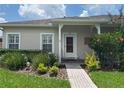 Inviting single-story home with brick walkway, lush greenery and great curb appeal at 314 Lake Butler Dr, Kissimmee, FL 34759