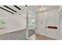 Bright entryway with tile flooring and view into the living room at 454 San Jose Dr, Winter Haven, FL 33884