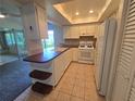 Efficient kitchen with white cabinets, neutral countertop and a convenient breakfast bar area at 454 San Jose Dr, Winter Haven, FL 33884