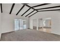 Open concept living room with neutral carpet and access to outdoor space at 454 San Jose Dr, Winter Haven, FL 33884