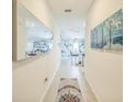 Inviting hallway with unique décor and a view into the spacious living and dining area at 621 Silver Palm Dr, Haines City, FL 33844