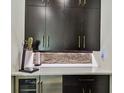 Stylish bar area features dark wood cabinets and white countertop at 12684 Willstatter Ave, Orlando, FL 32827