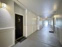 Well-lit hallway showcasing neutral walls and trim, leading to units within the building at 202 E South St # 5050, Orlando, FL 32801