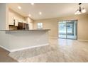 Open floor plan kitchen and dining room with tile floors and access to outdoor patio through sliding glass doors at 4887 Sw 159Th Lane Rd, Ocala, FL 34473